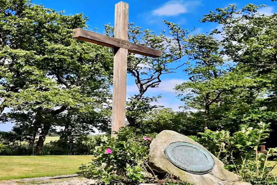 A Gravestone And A Large Wooden Cross Characterize The Atmospheric Picture Of The Cemetery Of The Nameless On Neuwerk. The Scenery Radiates Tranquility And Contemplation While Remembering The Nameless Souls Who Found Their Final Resting Place Here.