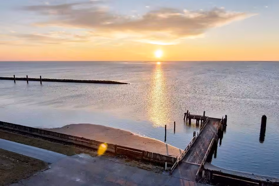 The Water, Slowly Receding At Low Tide, Reveals The Small Beach.